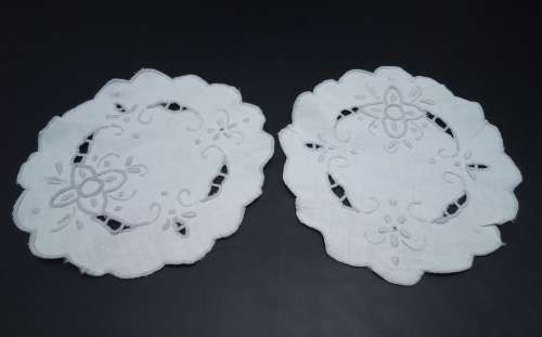 Two lovely small embroidered cutwork doilies
