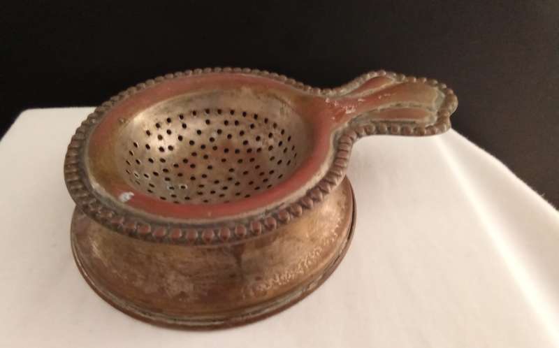 Very old tea strainer with holder