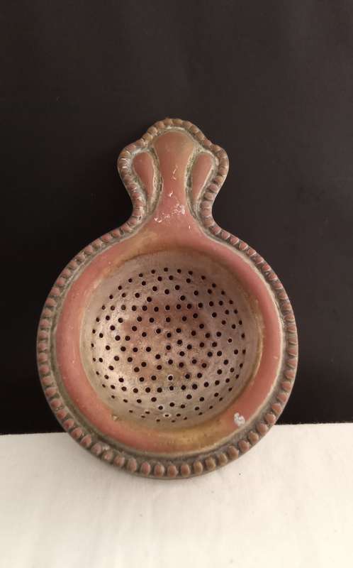 Very old tea strainer with holder