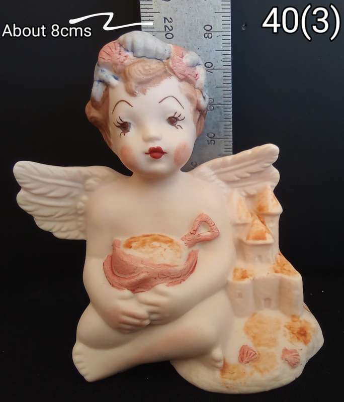 Beautiful  hand painted porcelain Angel with orange beach bucket