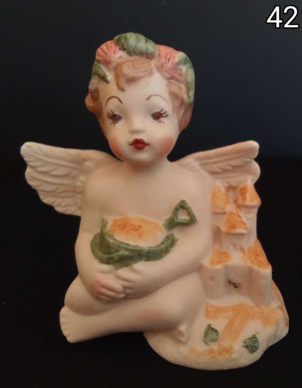 Beautiful  hand painted porcelain Angel with green beach bucket