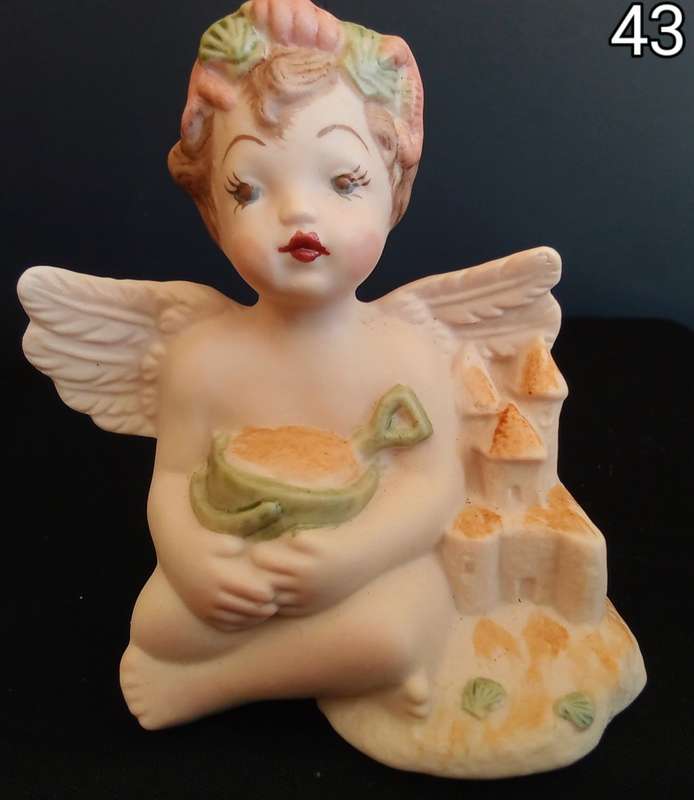 Beautiful  hand painted porcelain Angel with green beach bucket