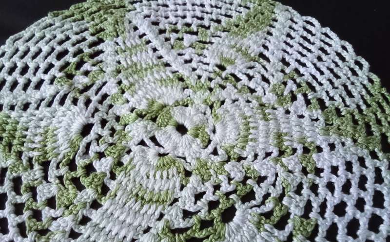 Beautiful white and green crocheted doily - about 25cms across