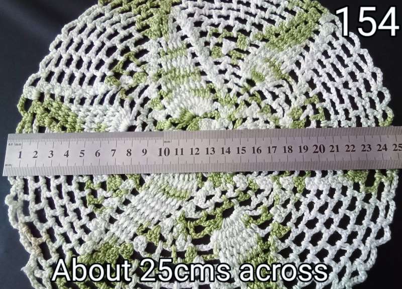 Beautiful white and green crocheted doily - about 25cms across