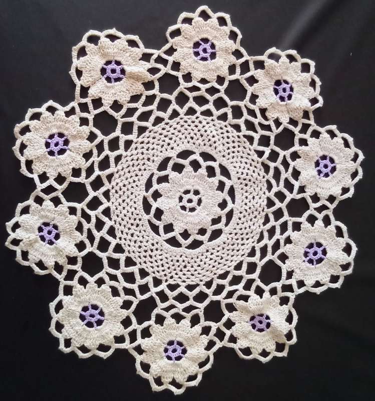 Lovely beige crocheted doily with purple flowers - about 38cms across