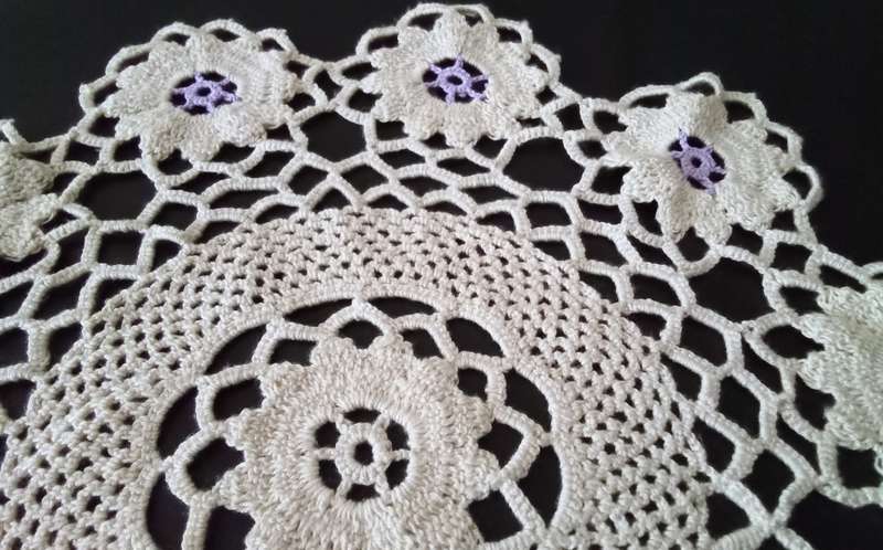 Lovely beige crocheted doily with purple flowers - about 38cms across