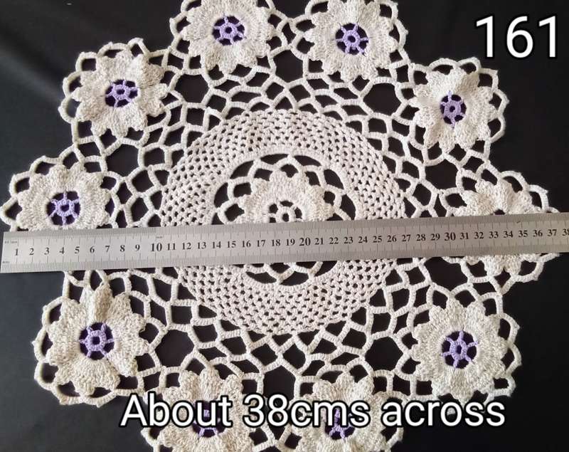 Lovely beige crocheted doily with purple flowers - about 38cms across