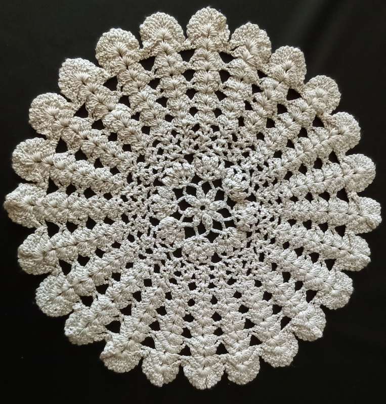 Beautiful beige crocheted doily - about 28cms across