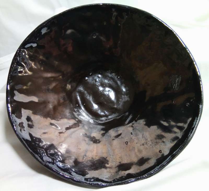Stunning solid pottery bowl with a dark iridescent glaze inside