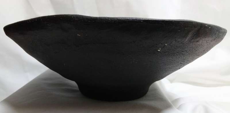 Stunning solid pottery bowl with a dark iridescent glaze inside