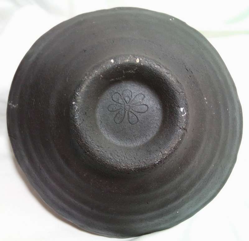 Stunning solid pottery bowl with a dark iridescent glaze inside