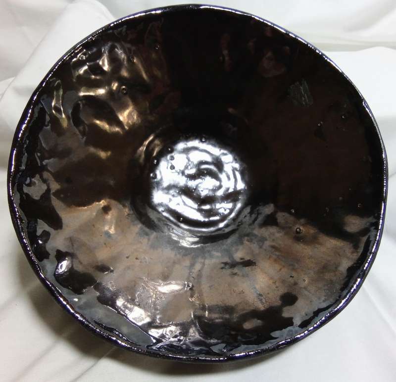 Stunning solid pottery bowl with a dark iridescent glaze inside