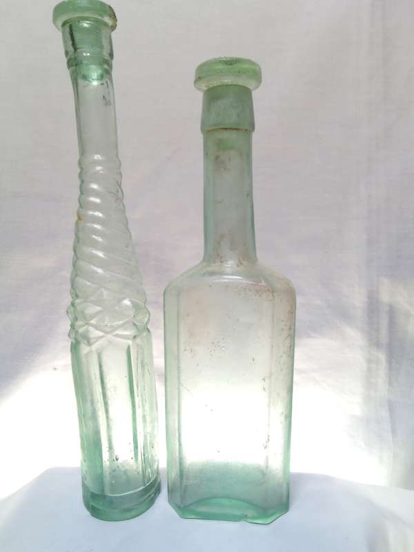 Two Vintage bottles with two glass tops
