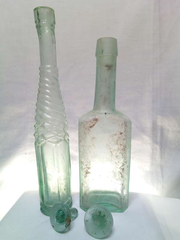 Two Vintage bottles with two glass tops