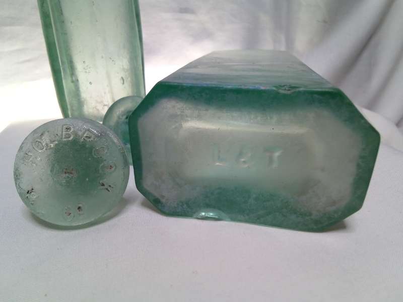 Two Vintage bottles with two glass tops