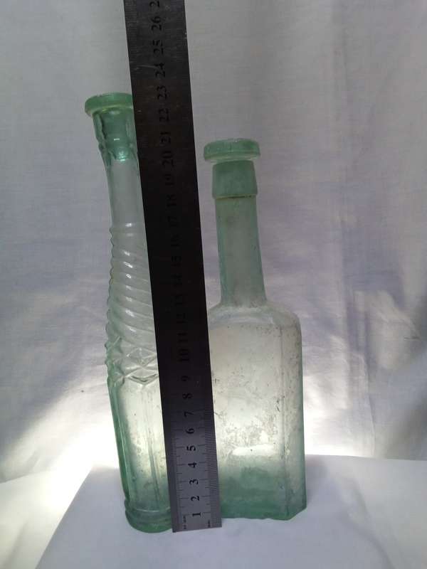 Two Vintage bottles with two glass tops