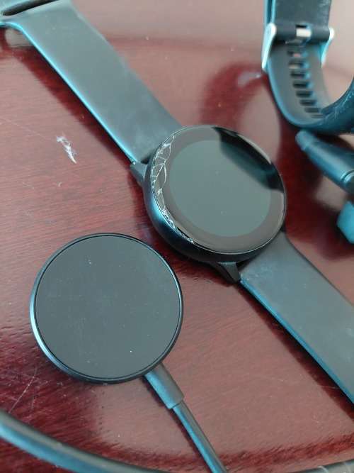 1x TomTom watch with earphones and charger & 1x Samsung Galaxy Watch with charger