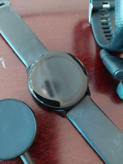 1x TomTom watch with earphones and charger & 1x Samsung Galaxy Watch with charger