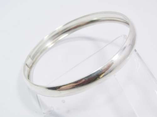 A Lovely Broad D Shape Bangle in Sterling Silver.