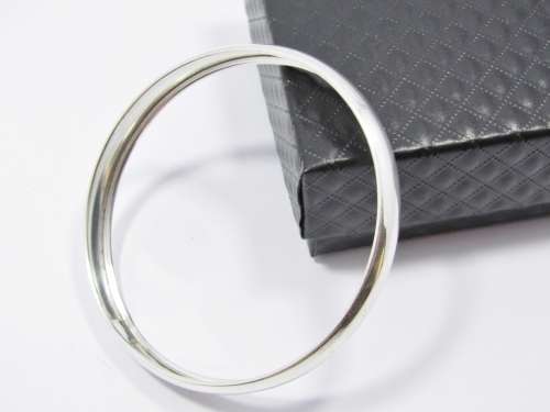 A Lovely Broad D Shape Bangle in Sterling Silver.