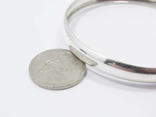 A Lovely Broad D Shape Bangle in Sterling Silver.