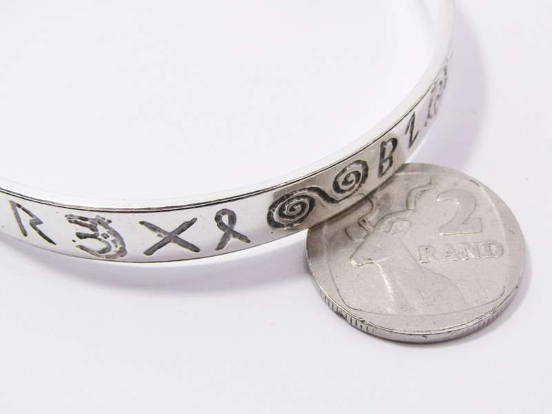 A Stunning Rustic Runic Design Bangle in Sterling Silver.