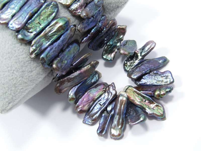 A Beautiful String Of Free Form Peacock Color Pearl Necklace With a Sterling Silver Clasp.