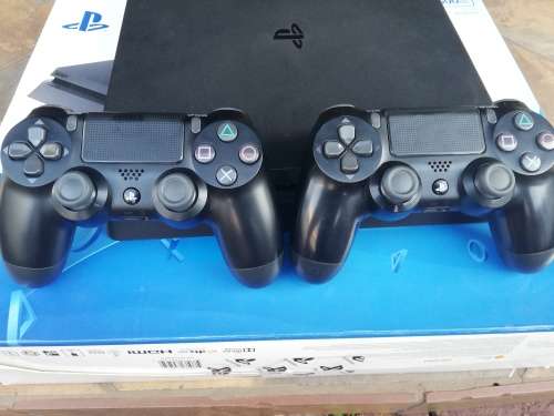 PS4 Slim Console, 2x Original Remotes, 4x Games