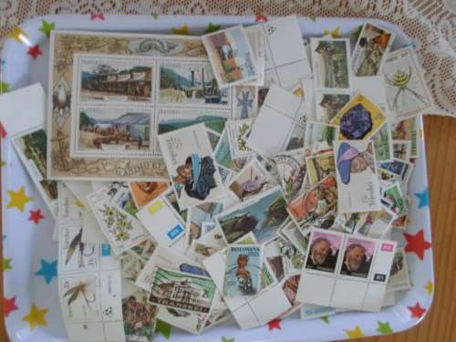 500 X TRANSKEI AND BOTSWANA MINT AND USED STAMPS OFF PAPER