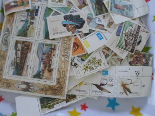 500 X TRANSKEI AND BOTSWANA MINT AND USED STAMPS OFF PAPER
