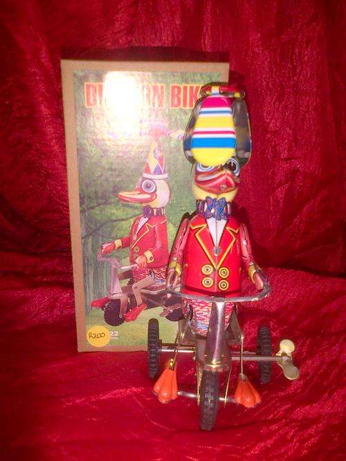 Metal wind up duck riding bike.