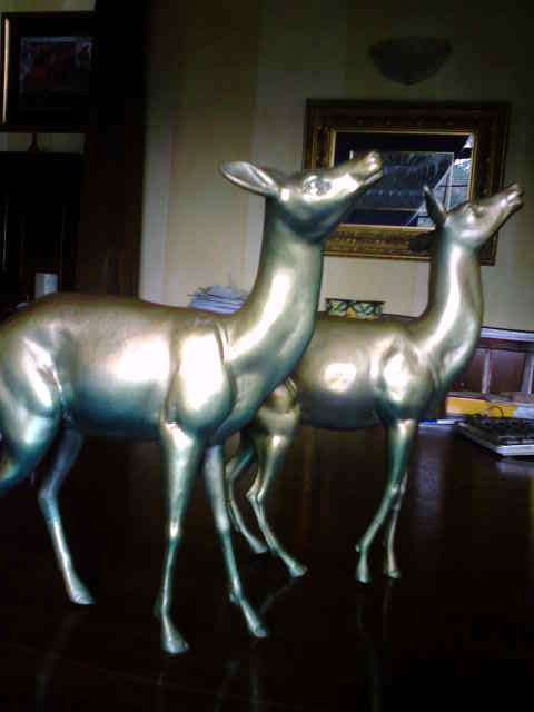 A  pair of pewter deers