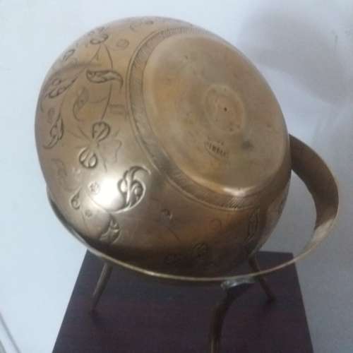 Ornate brass bowl on a stand holding a vase - stunning of craftsmanship piece- different