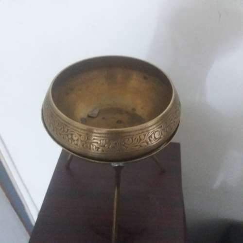 Ornate brass bowl on a stand holding a vase - stunning of craftsmanship piece- different