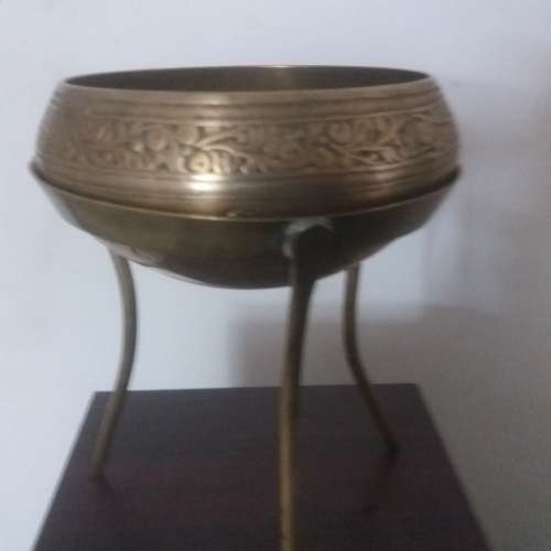 Ornate brass bowl on a stand holding a vase - stunning of craftsmanship piece- different