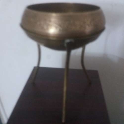 Ornate brass bowl on a stand holding a vase - stunning of craftsmanship piece- different