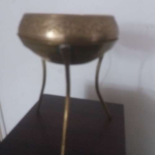 Ornate brass bowl on a stand holding a vase - stunning of craftsmanship piece- different