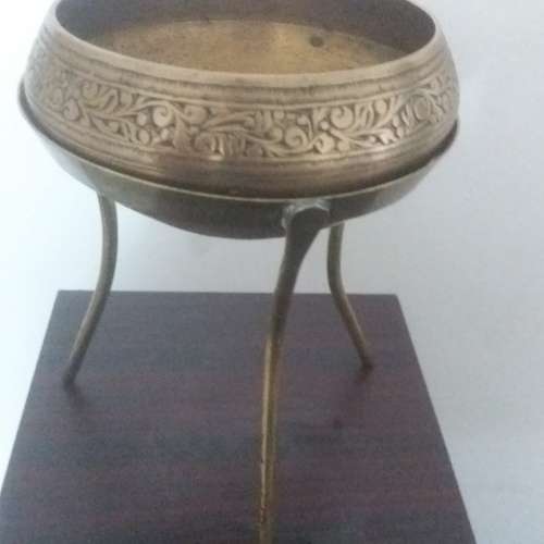 Ornate brass bowl on a stand holding a vase - stunning of craftsmanship piece- different