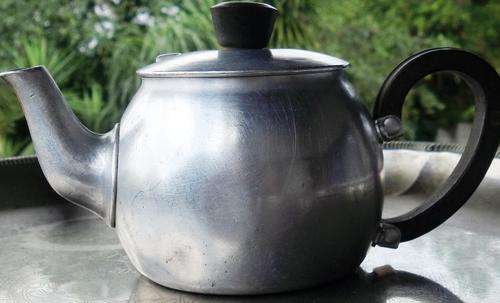 Tiny Baby kettle with tea-cozy.