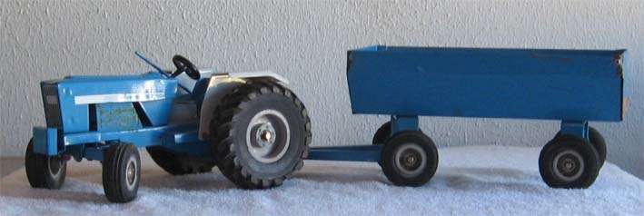 TIN PLATE FORD TRACTOR AND TRAILER by STRIKE TOYS/SPEELGOED
