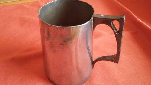 110-year-old military whisky tankard with bullet hole