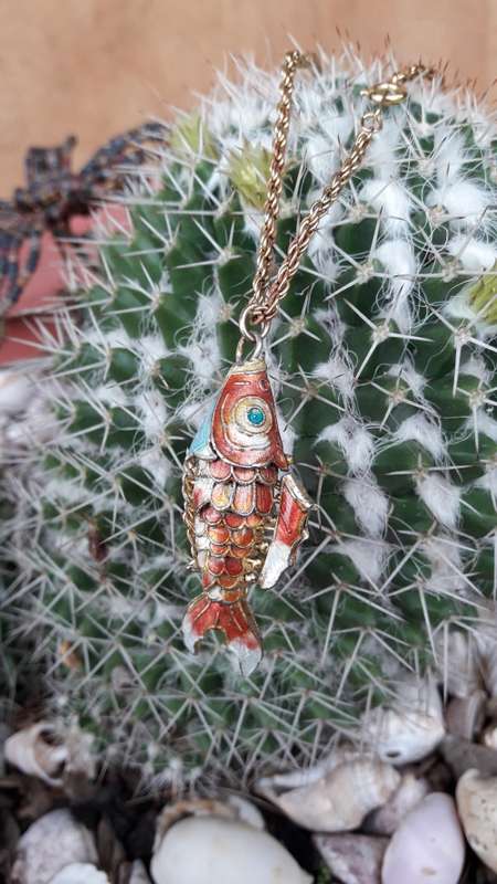 An enamel fish necklace