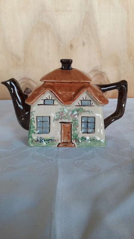 A hand painted cottage teapot