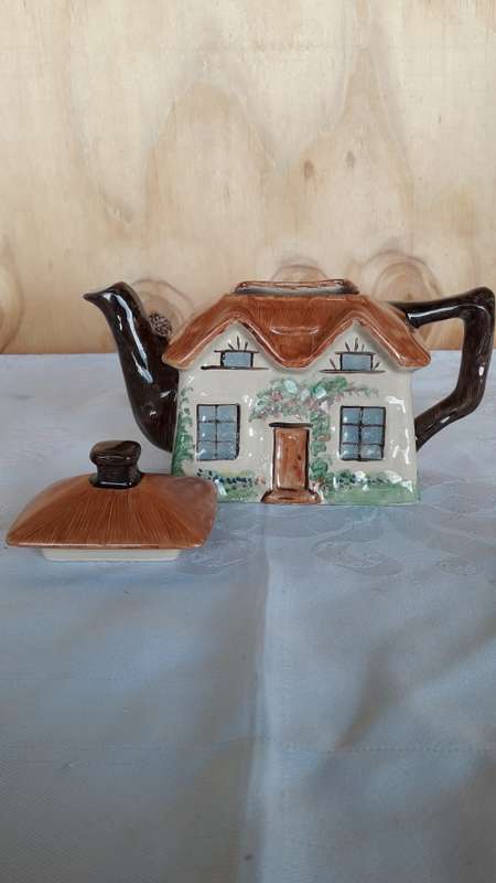 A hand painted cottage teapot