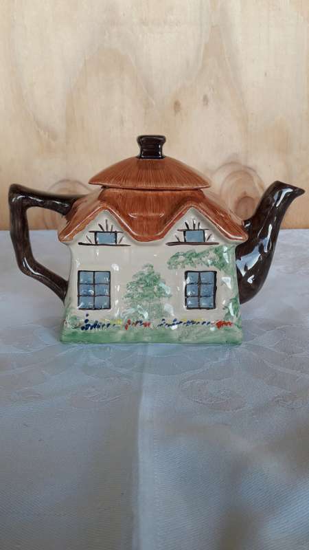 A hand painted cottage teapot