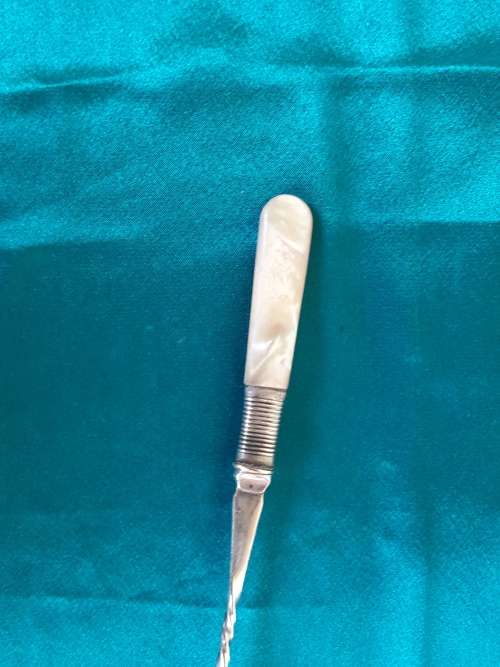A beautiful silver plated, mother of pearl pickle fork