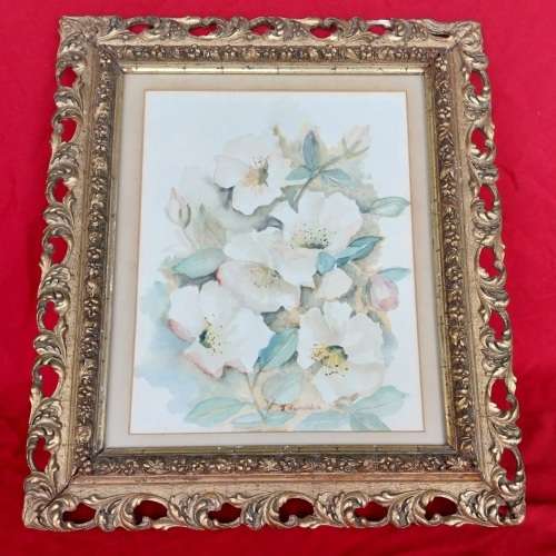 A signed watercolor painting in a decorative frame