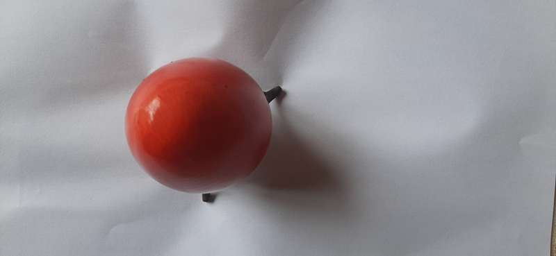 RED ALABASTER EGG ON A BRASS TRIPOD