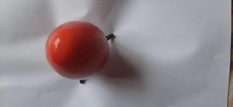 RED ALABASTER EGG ON A BRASS TRIPOD
