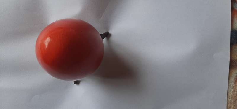RED ALABASTER EGG ON A BRASS TRIPOD